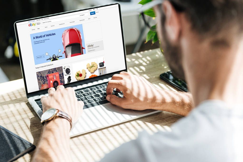 cropped view of man using laptop with ebay website on screen - Photo, Image
