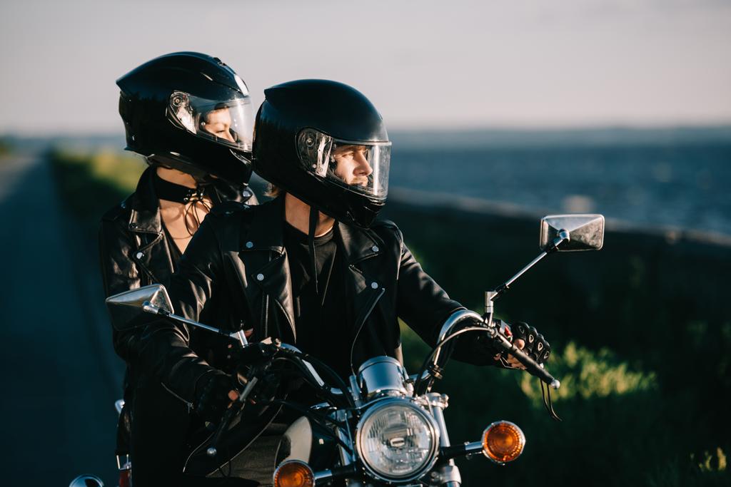 couple of bikers in helmets riding motorcycle - Photo, Image
