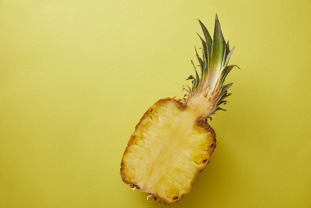top view of half of pineapple on yellow surface - Photo, Image