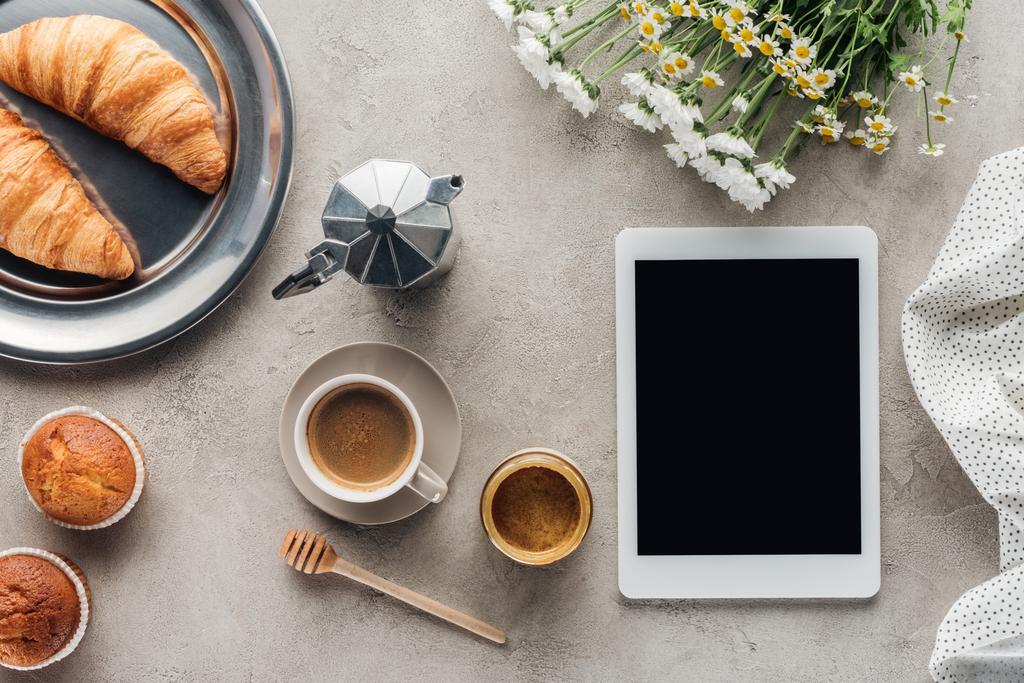 top view of coffee with pastry and tablet with blank screen on concrete surface - Photo, Image