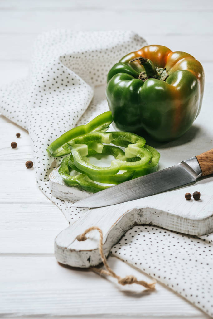 ripe cut and whole bell peppers on white wooden board - Photo, Image