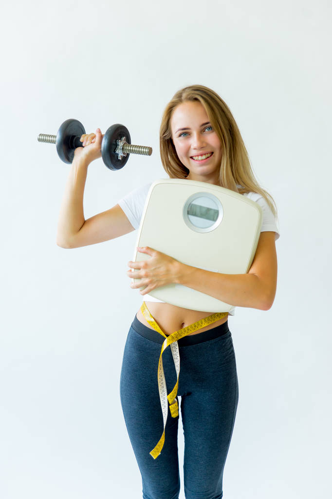 Fit woman measuring waist with measuring tape - Photo, Image