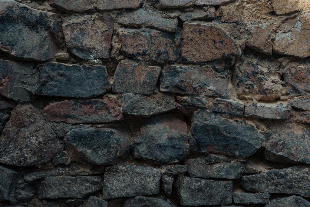 close-up view of dark grey stone wall texture - Photo, Image