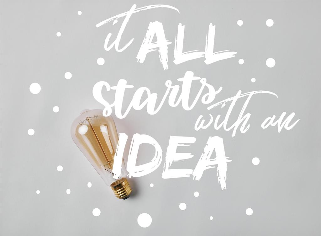 винтажная лампа накаливания на белой поверхности с вдохновением "все начинается с идеи"
  - Фото, изображение