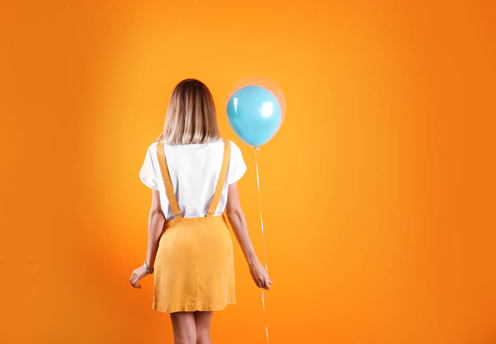 Young woman with air balloon on color background - Photo, Image