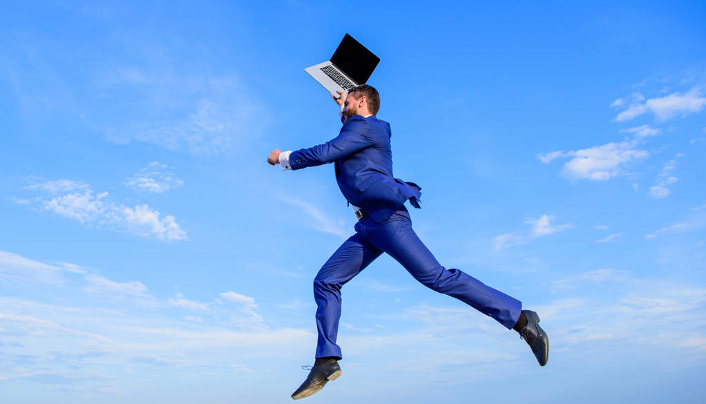 Businessman inspired entrepreneur feels powerful going to change world. Man inspired holds laptop above while jump. Follow your dream. Businessman formal suit follow laptop. Inspiring innovations - Photo, Image