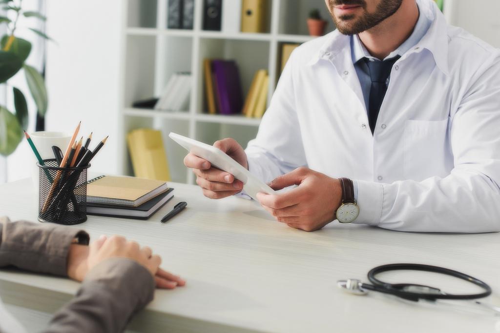 cropped image of doctor holding tablet in clinic - Photo, Image