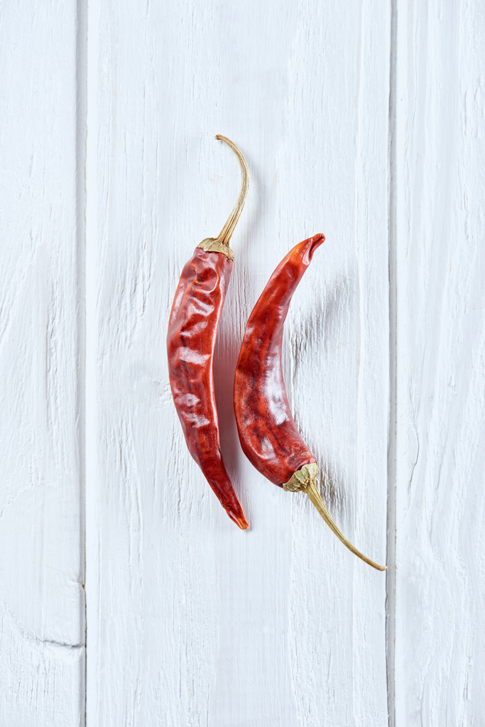 top view of chili peppers on white wooden surface - Photo, Image
