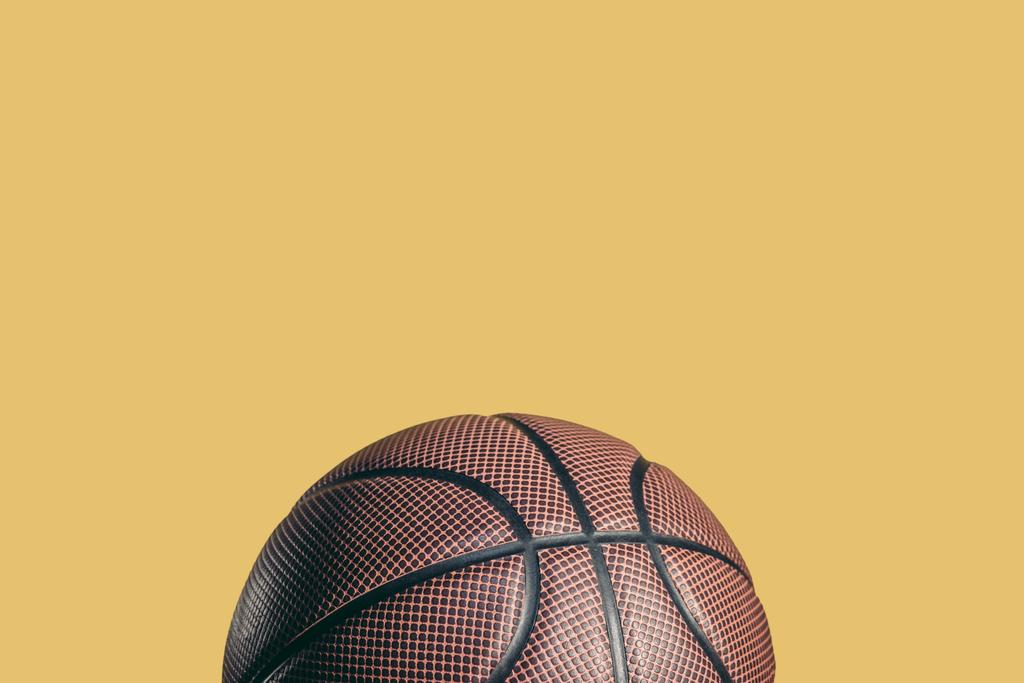 one rubber brown basketball ball isolated on yellow - Photo, Image