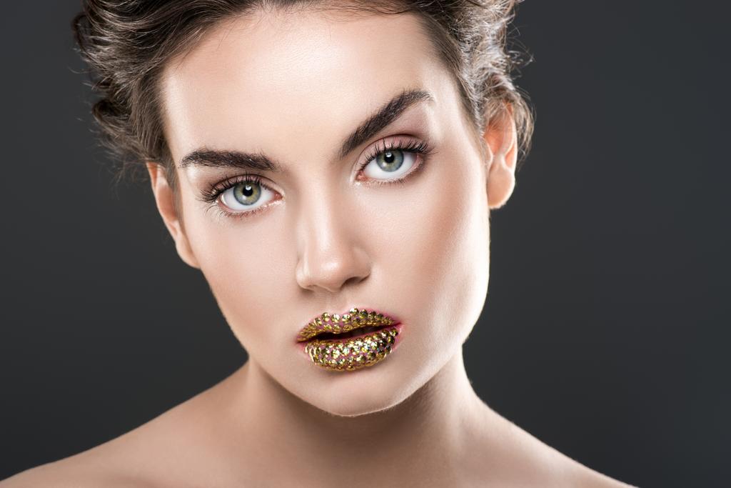 beautiful woman with golden lips, isolated on grey - Photo, Image