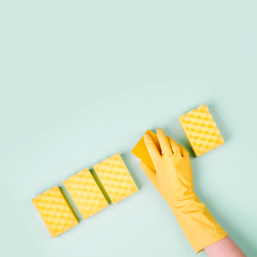 top view of cleaner hand in glove with sponges on blue background - Photo, Image