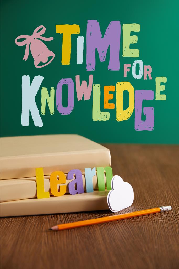 libros, lápiz, signo de nube y aprender letras en la mesa de madera con letras de "tiempo para el conocimiento"
 - Foto, imagen