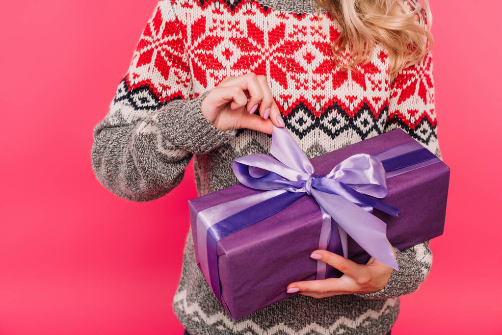 cropped image of girl in sweater opening present in violet box isolated on pink - Photo, Image