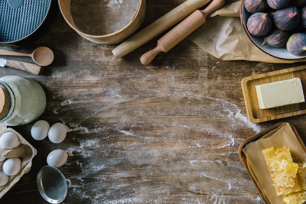 top view of messy wooden table with spilled flour and baking ingredients - Photo, Image