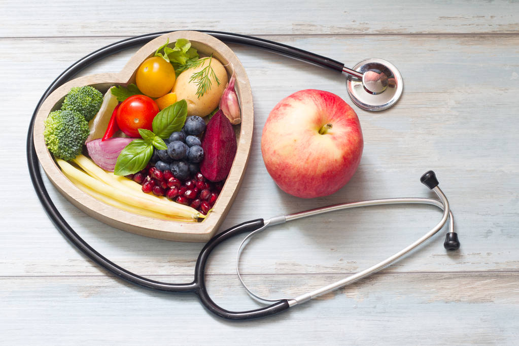 Healthy food in heart diet concept with stethoscope - Photo, Image