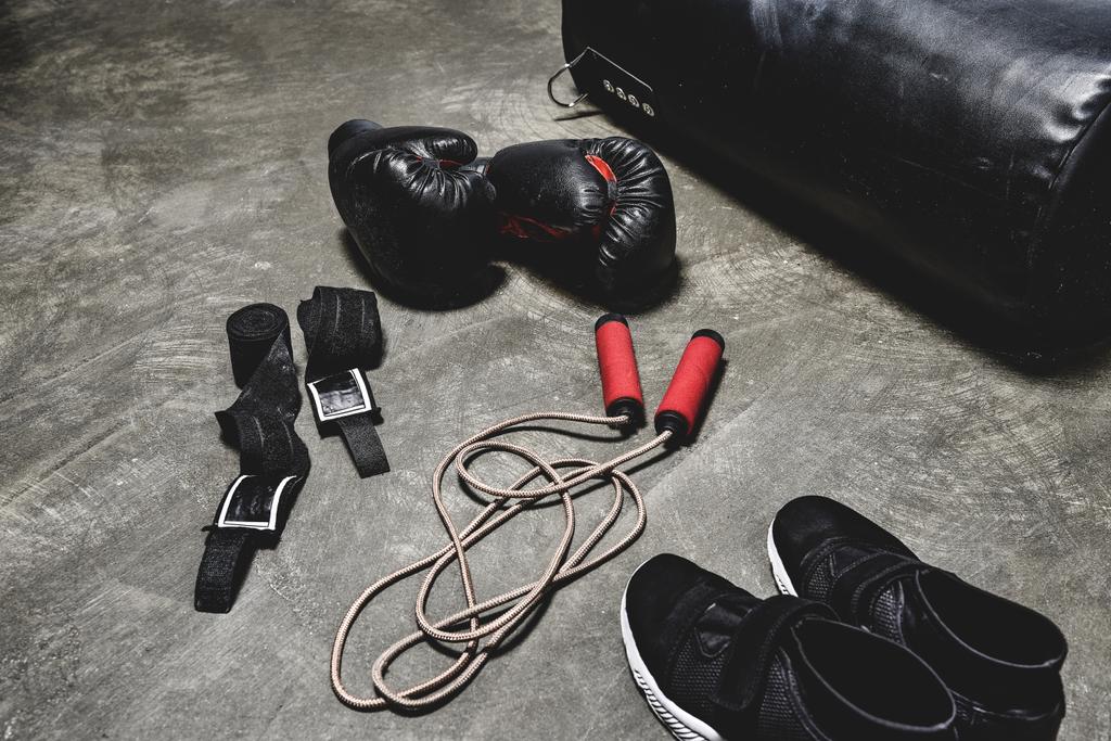 various boxing equipment lying on concrete surface - Photo, Image