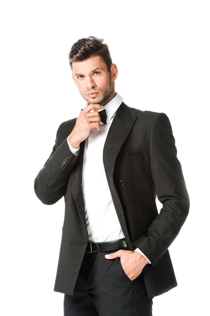 thoughtful groom in black suit looking at camera isolated on white - Photo, Image