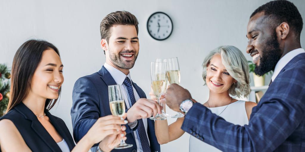 панорамный вид на мультиэтнических бизнесменов, звенящих с бокалами шампанского в офисе
 - Фото, изображение