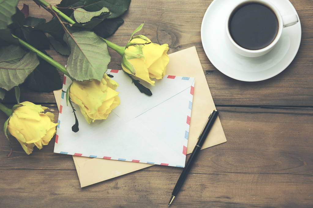 κίτρινα τριαντάφυλλα με σελίδα και καφέ στο ξύλινο τραπέζι - Φωτογραφία, εικόνα