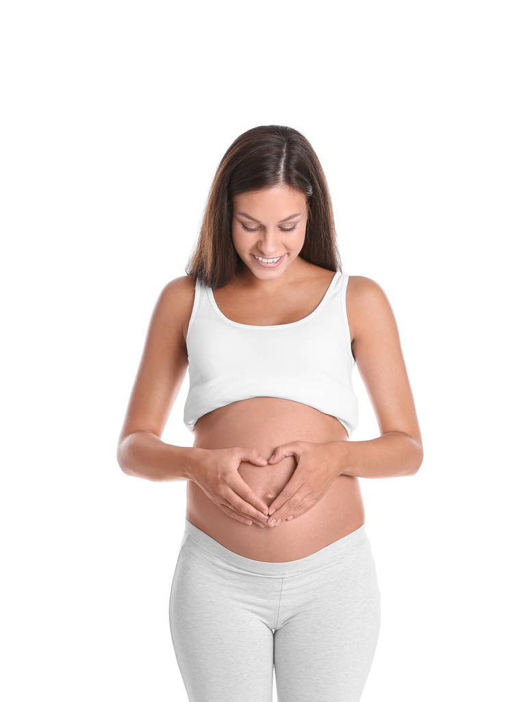 Gelukkig zwangere vrouw die zich voordeed op witte achtergrond - Foto, afbeelding