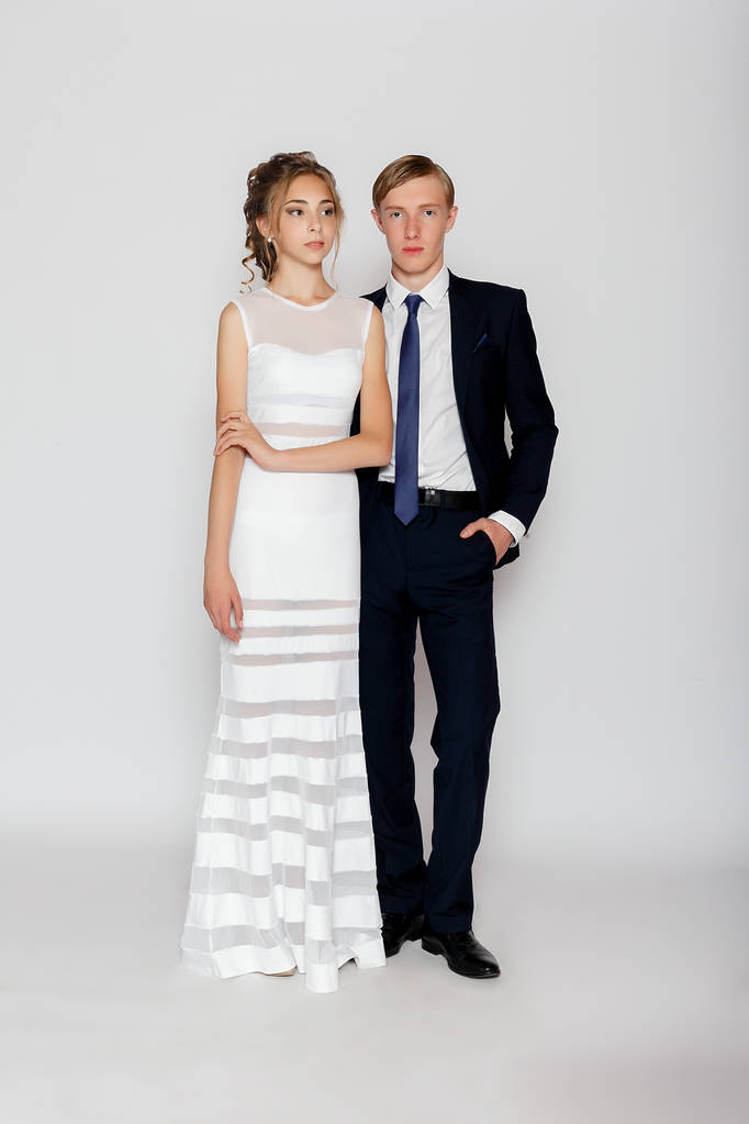 young fashion couple on a gray background in studio - Photo, Image