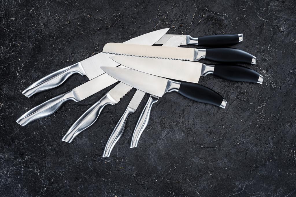set of various kitchen knives arranged on black, top view   - Photo, Image