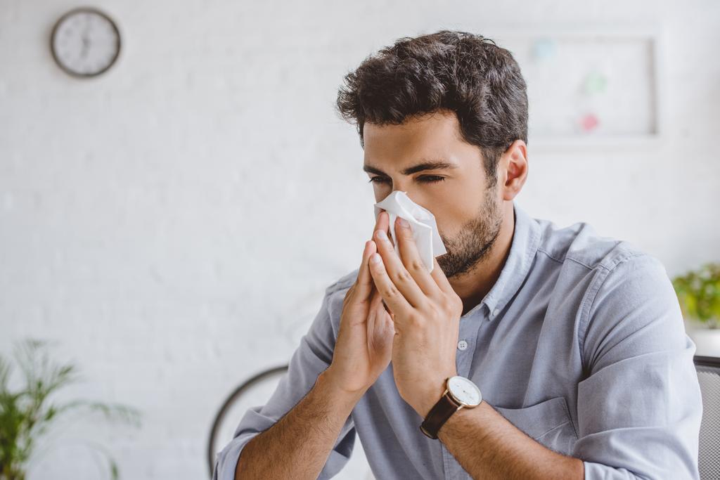 sick manager blowing nose in tissue in office - Photo, Image