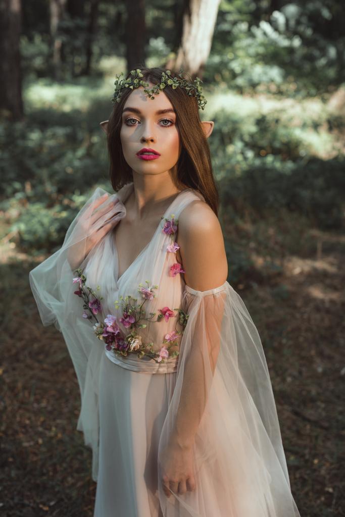 hermoso elfo místico en elegante vestido de flores en el bosque
 - Foto, Imagen