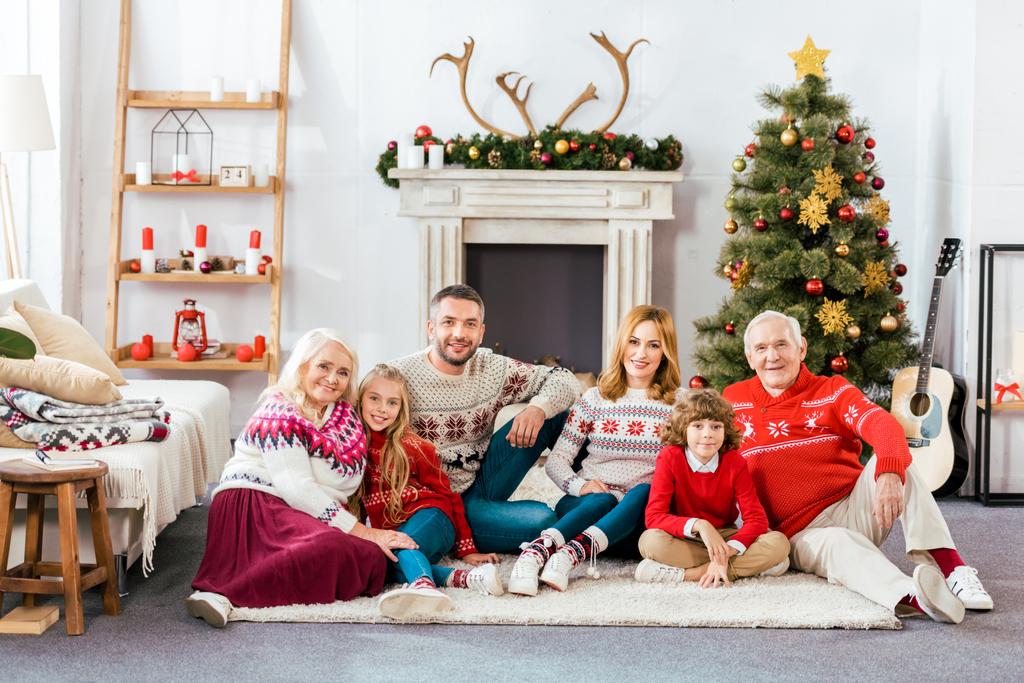 happy family sitting on floor together at home on christmas - Photo, Image