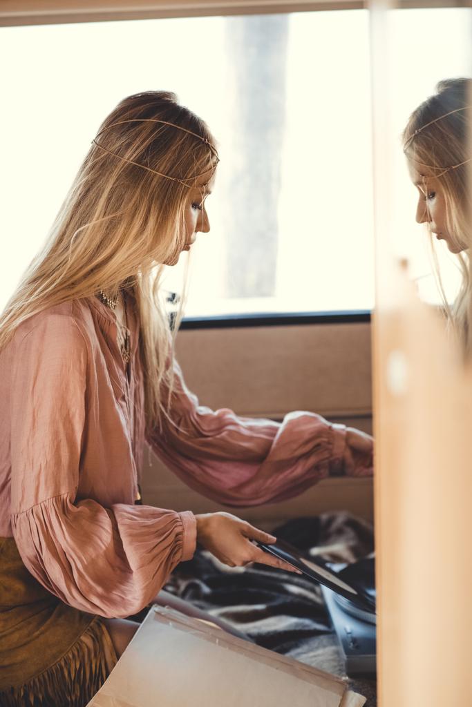 Blondes Hippie-Mädchen steckt Schallplatte in Wohnmobil - Foto, Bild