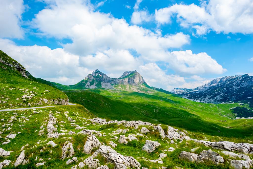 rocky mountains and blue cloudy sky in Durmitor massif, Montenegro - Photo, Image
