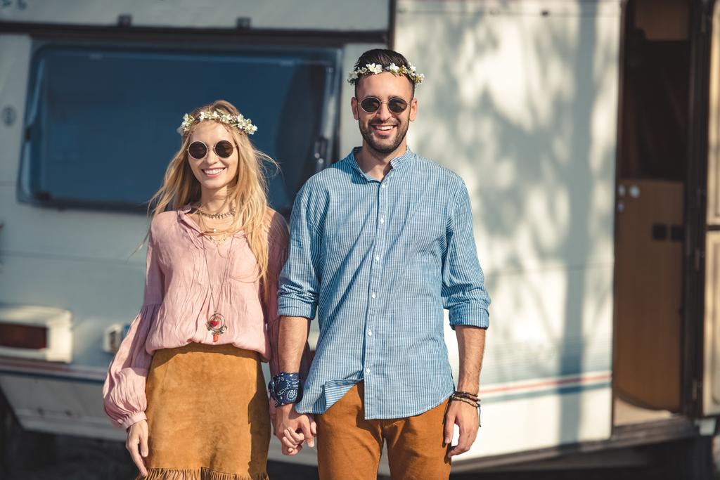 Hippie-Paar hält Händchen und posiert in der Nähe von Wohnwagen  - Foto, Bild