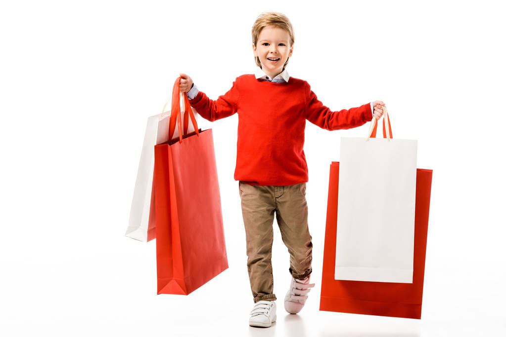 白で隔離大きな買い物袋を保持している小さな子供の幸せ - 写真・画像