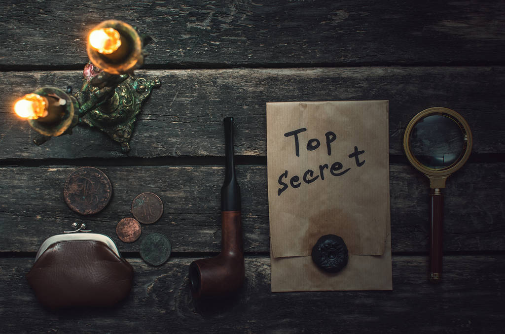 Top secret documents file, key, magnifying glass, smoking pipe and wallet with coins on the detective spy agent table background. - Photo, Image