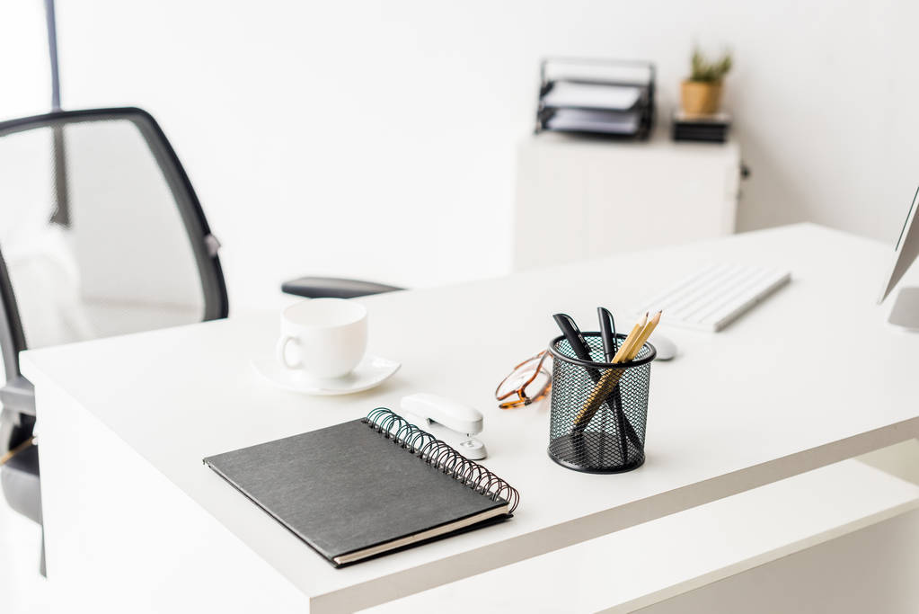 coffee cup and office supplies on white table at workplace - Photo, Image