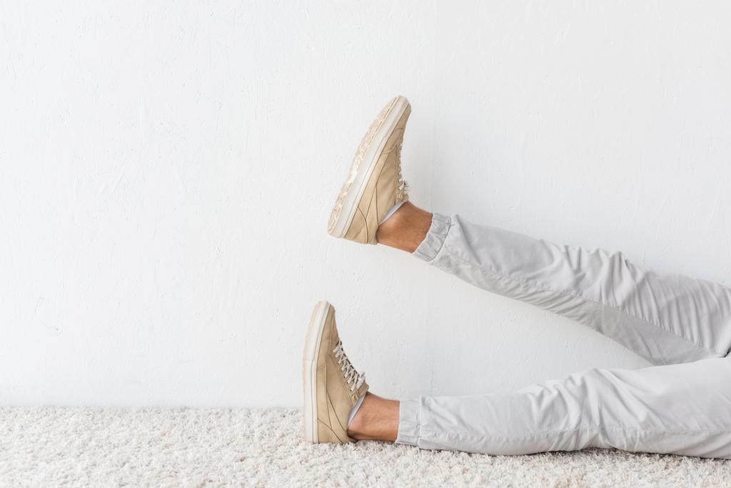 low section view of casual man on beige rug  - Photo, Image
