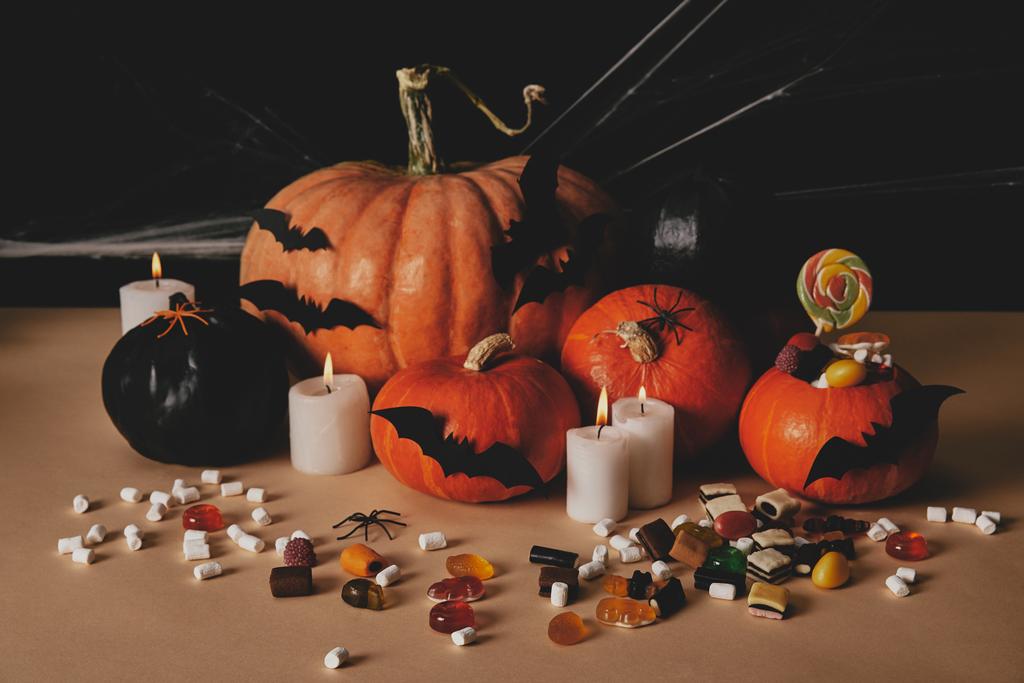 halloween still life with pumpkins, sweets and decoration on tabletop - Photo, Image