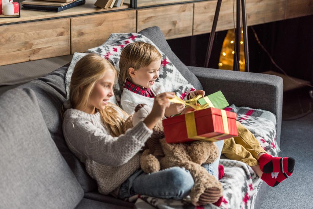 high angle view of cute happy kids opening christmas presents at home  - Photo, Image