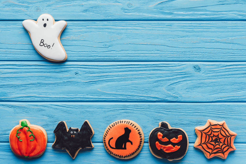 elevated view of spooky halloween cookies on blue wooden background  - Photo, Image