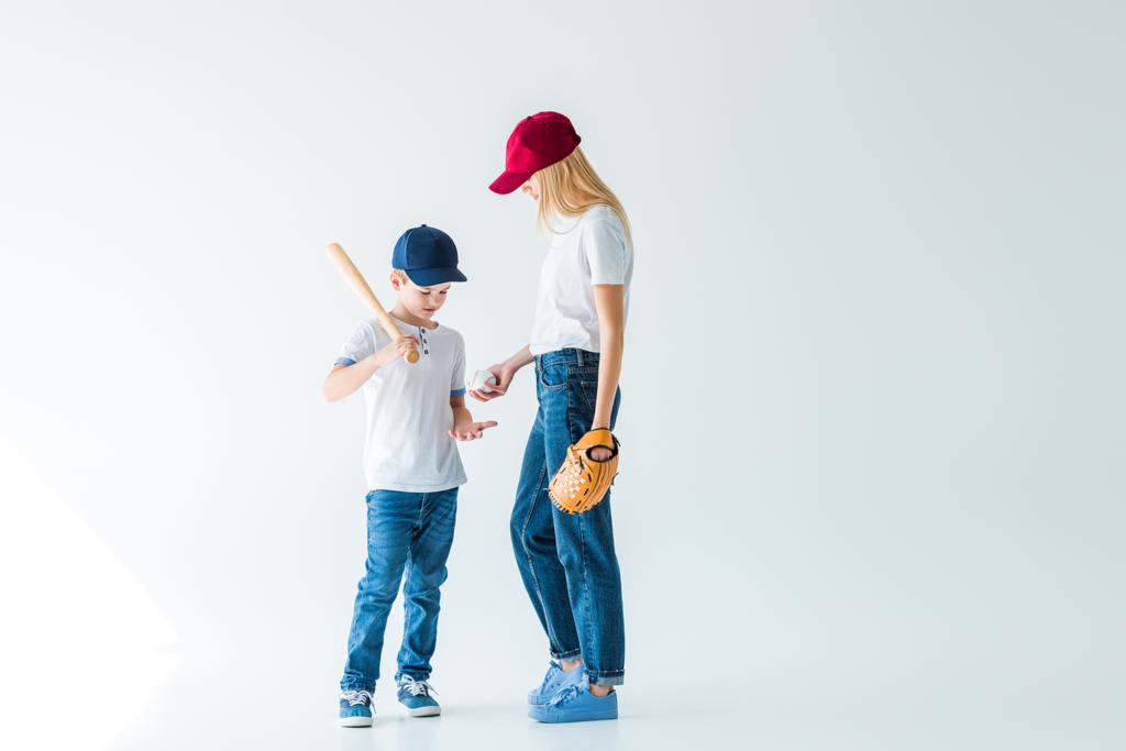 mother giving baseball ball to son on white - Photo, Image