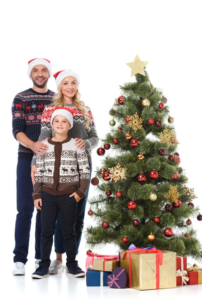family with son standing near christmas tree with presents, isolated on white - Photo, Image