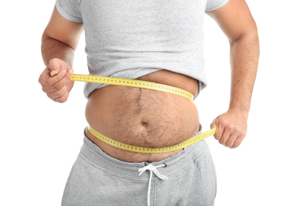 Uomo sovrappeso con metro su sfondo bianco, primo piano
 - Foto, immagini