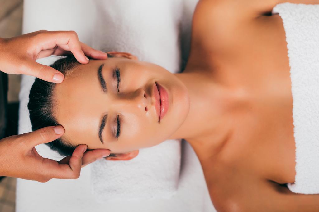 smiling woman relaxing in massage salon  - Photo, Image