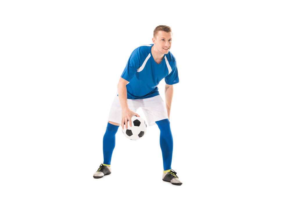 full length view of smiling young sportsman playing with soccer ball isolated on white - Photo, Image