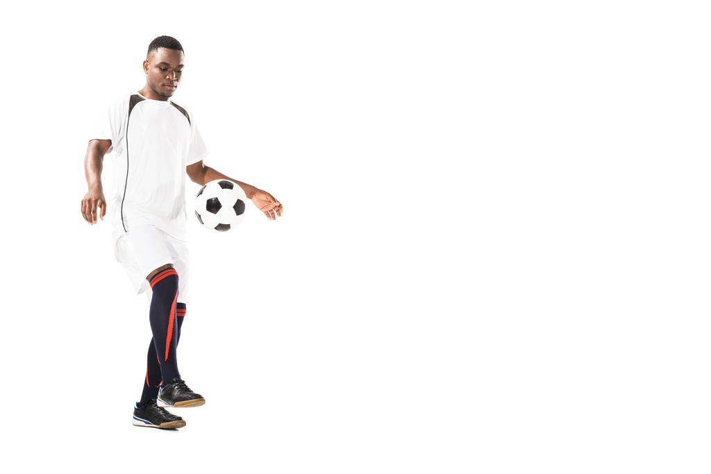 full length view of handsome young african american sportsman playing with soccer ball isolated on white - Photo, Image