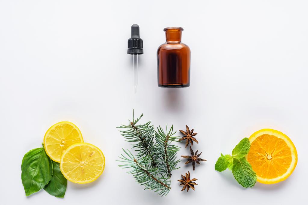 pohled shora láhve přírodní rostlinné silice, kapátko, jedle, citronovou a pomerančovou kusů izolované na bílém - Fotografie, Obrázek