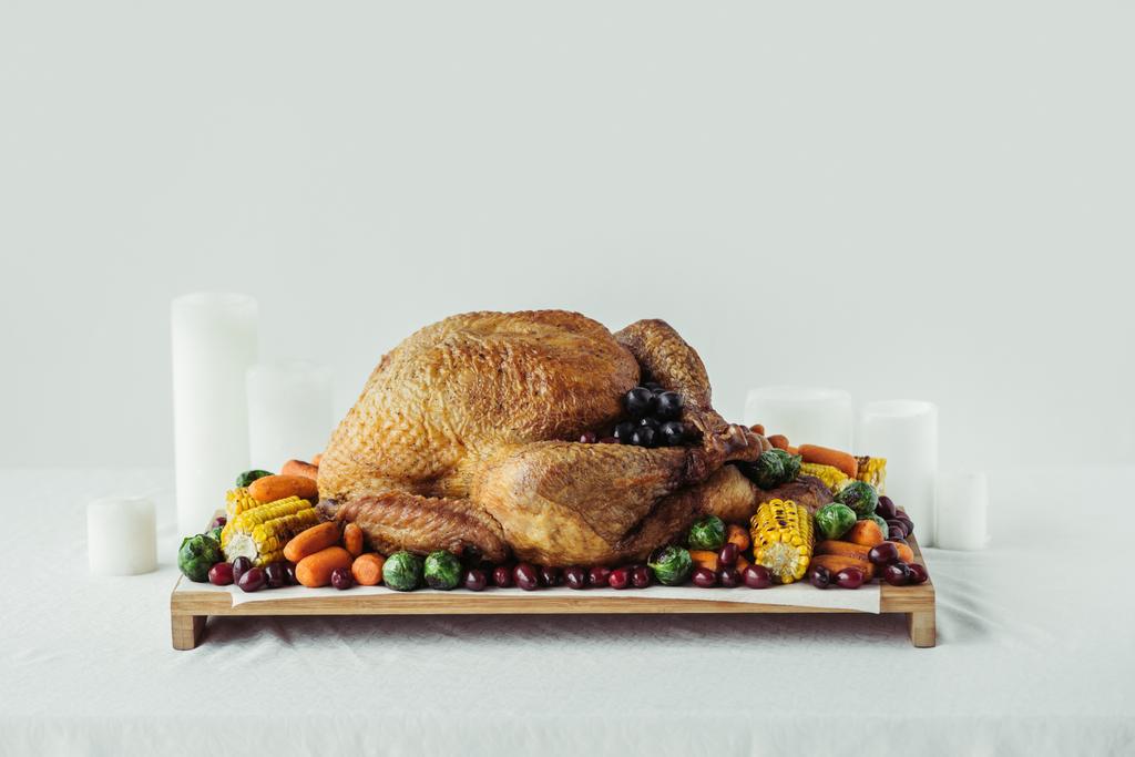 close up view of arranged candles, festive turkey with roasted vegetables for holiday dinner on tabletop, thanksgiving holiday concept - Photo, Image