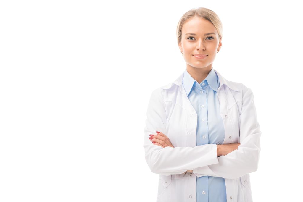 confident young female doctor with crossed arms looking at camera isolated on white - Photo, Image