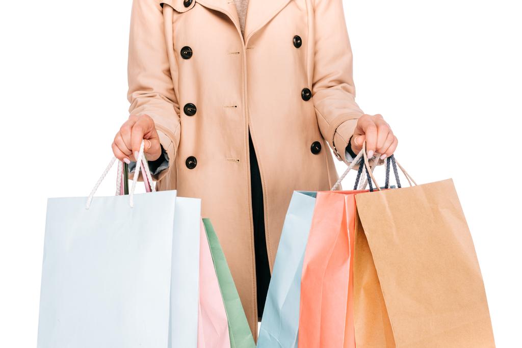 Schnappschuss einer jungen Frau mit Einkaufstüten auf weißem Grund  - Foto, Bild