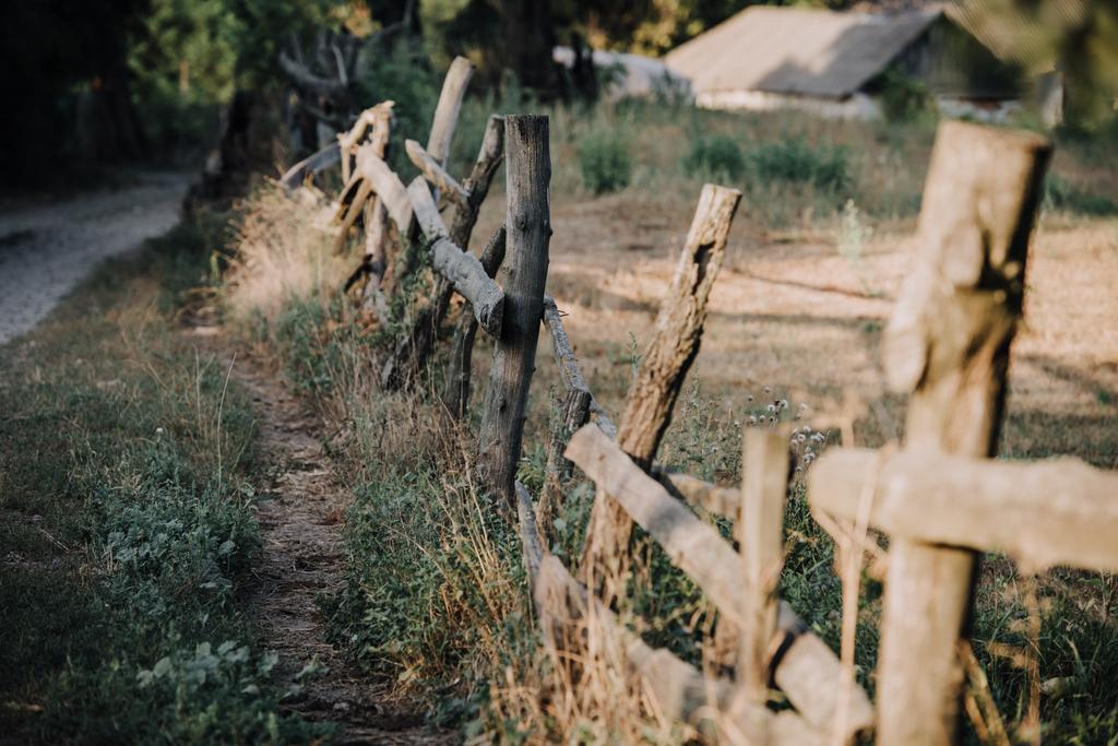 selective focus of wooden fence on meadow in countryside - Photo, Image